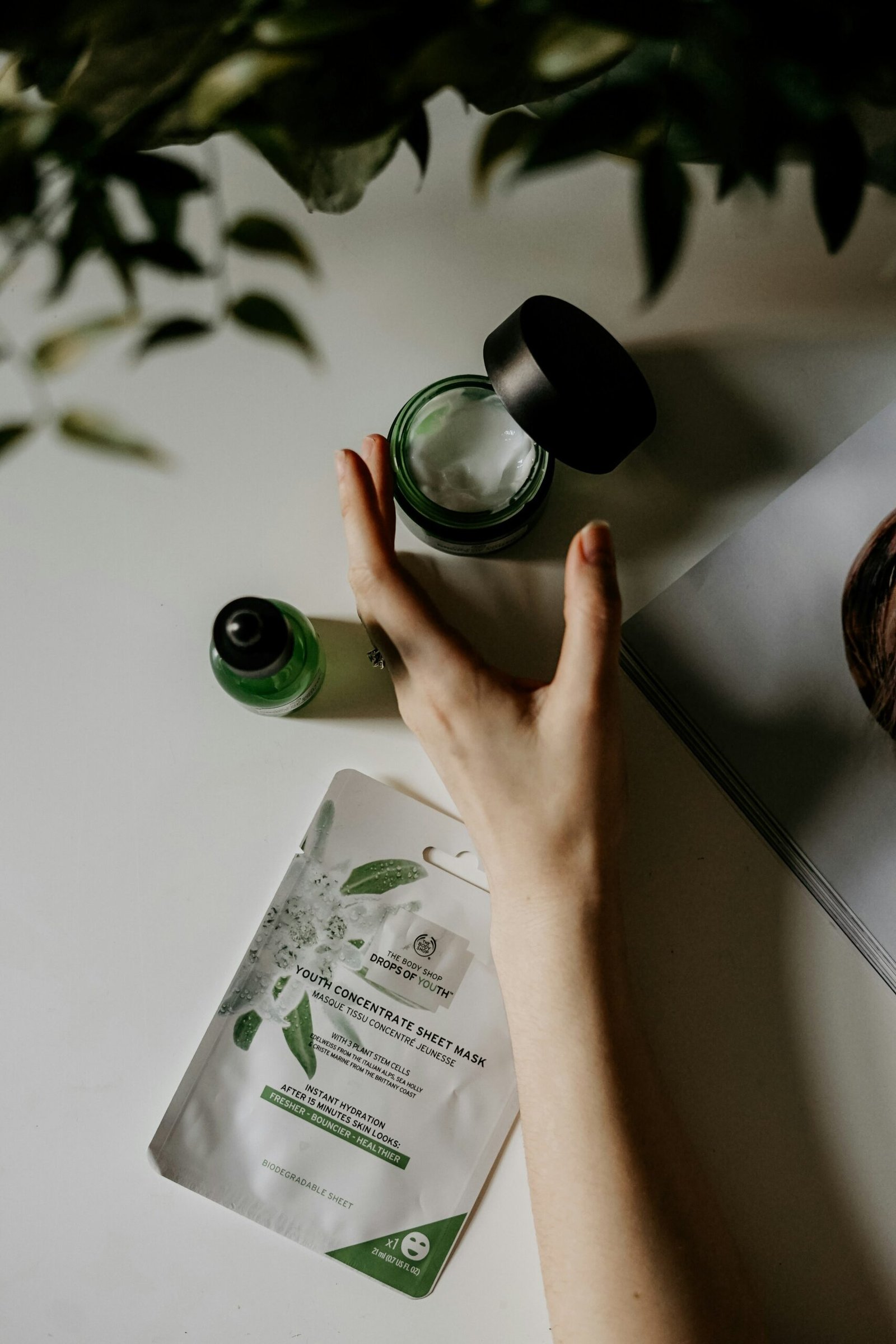 Featured image person touching black plastic bottle related to to Korean skincare brand