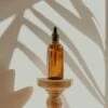 clear glass bottle on white wooden round table