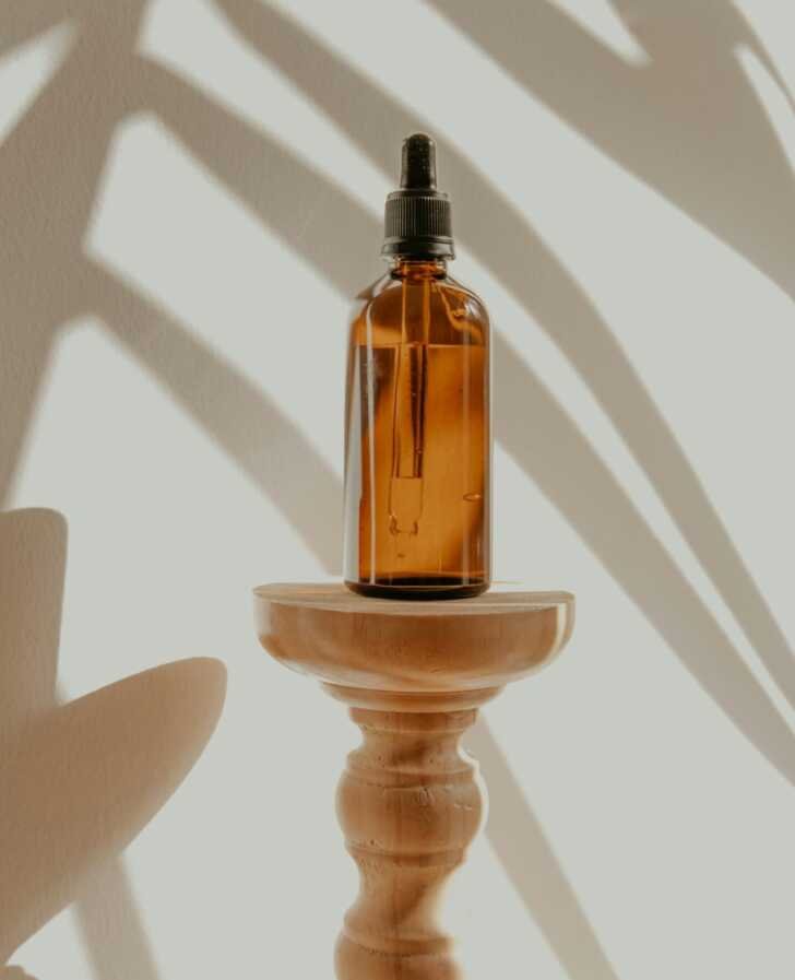 clear glass bottle on white wooden round table with the Ordinary Glycolic Acid 7% Toner